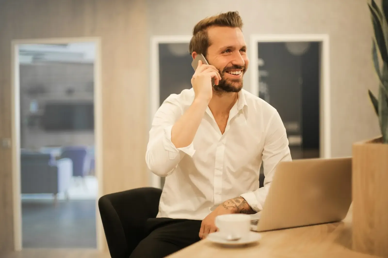 A moving company owner on a call at his desk