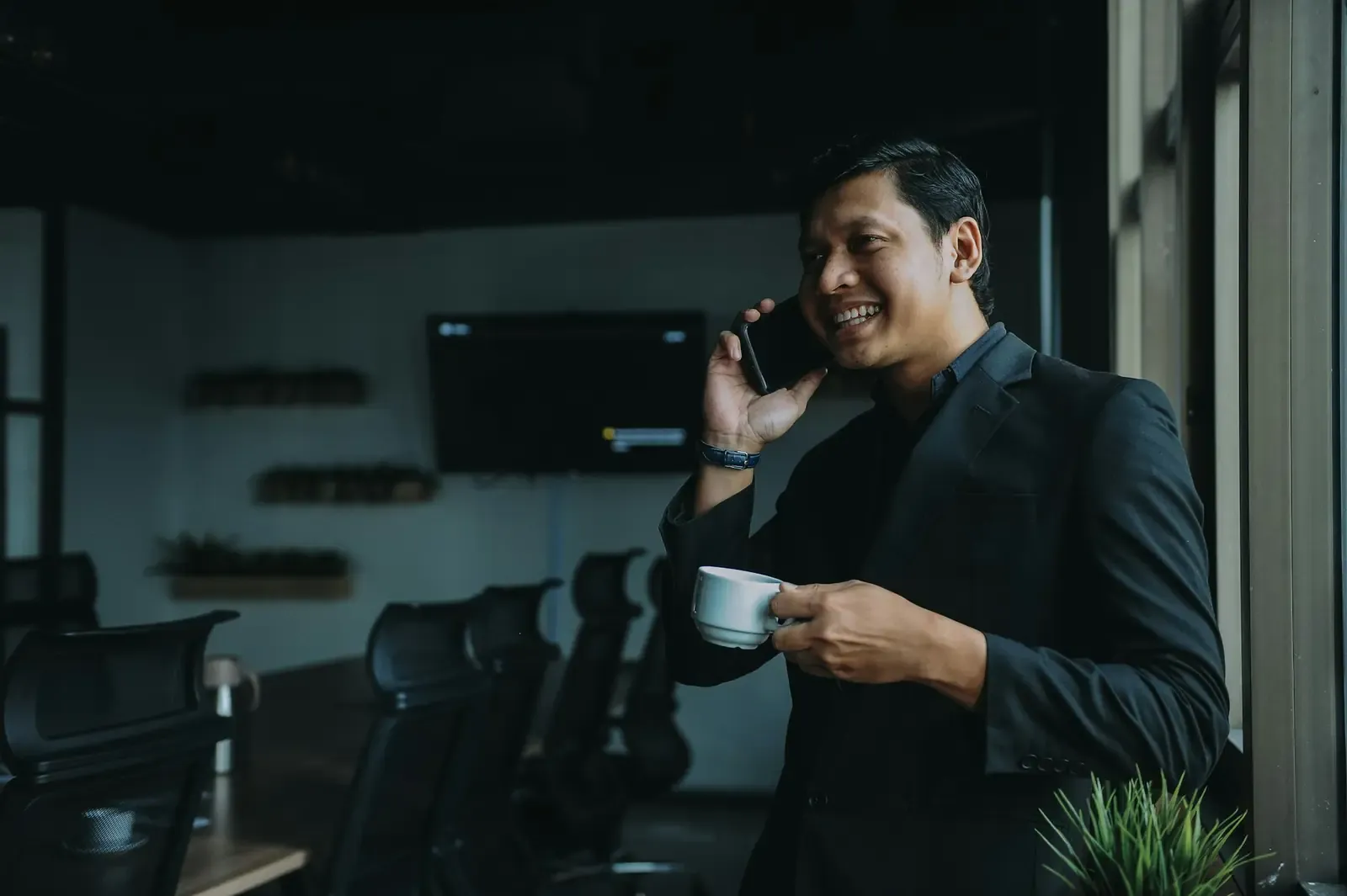 A moving company owner on a call in his office